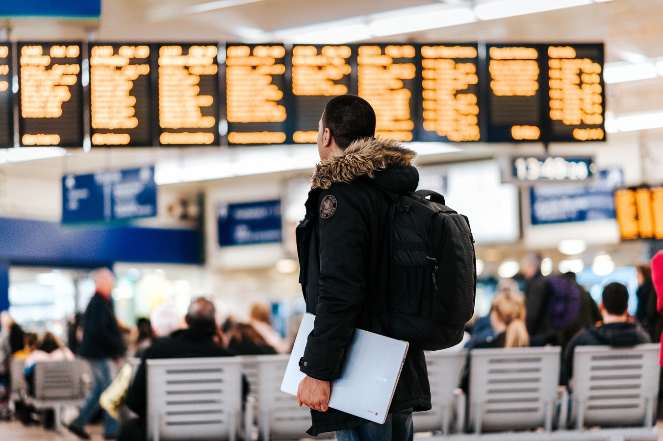 Traveller looking at airport flight screens