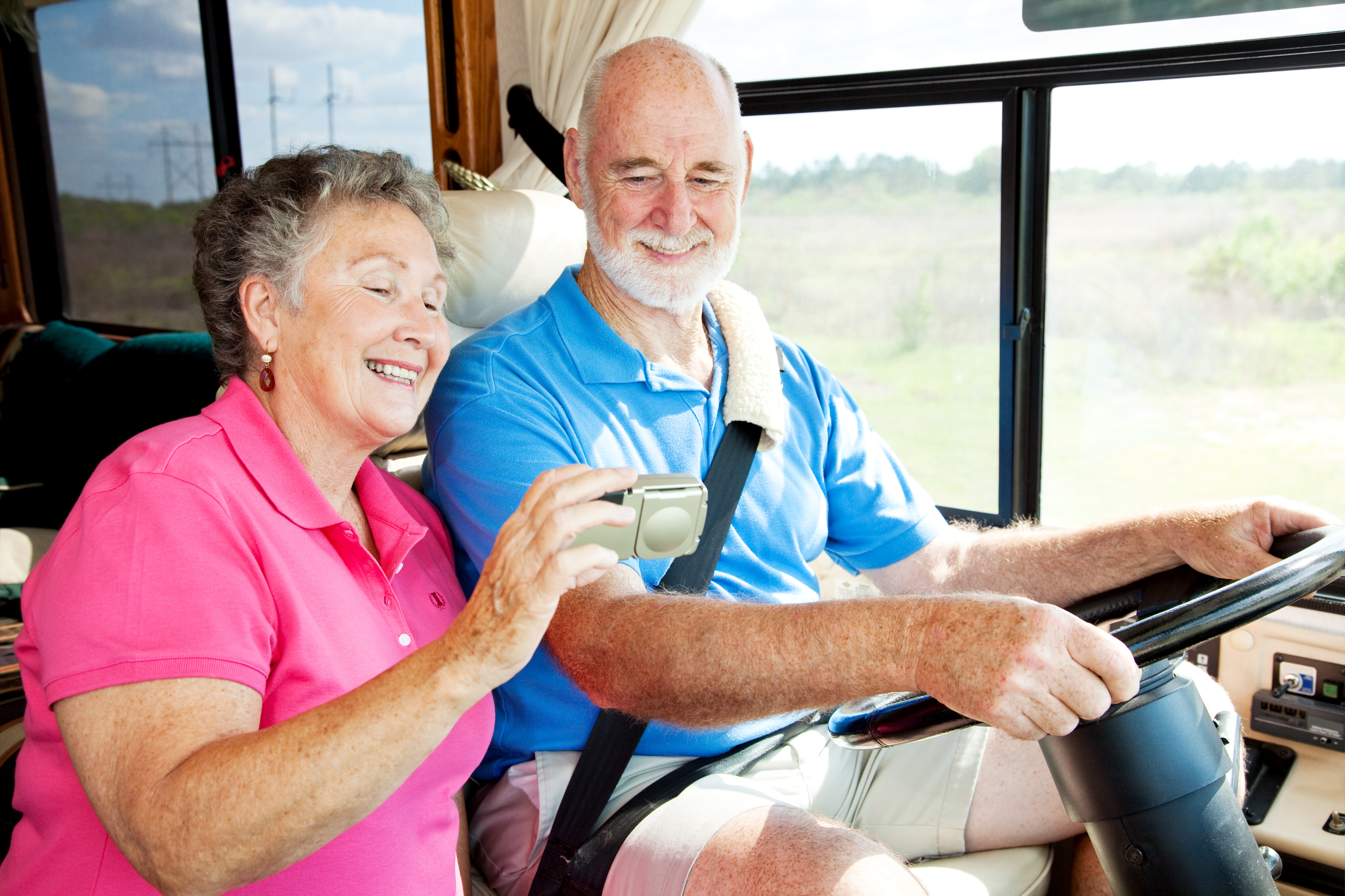 Senior couple driving campervan